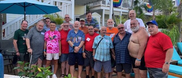 Group of men posing at an outdoor resort